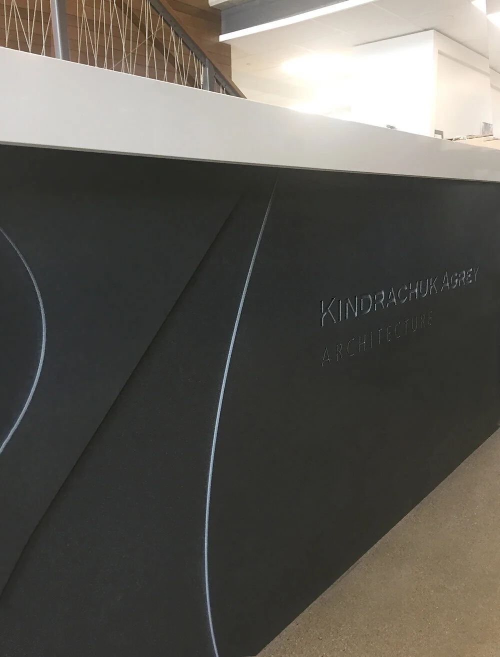Front desk logo application - routered granite.