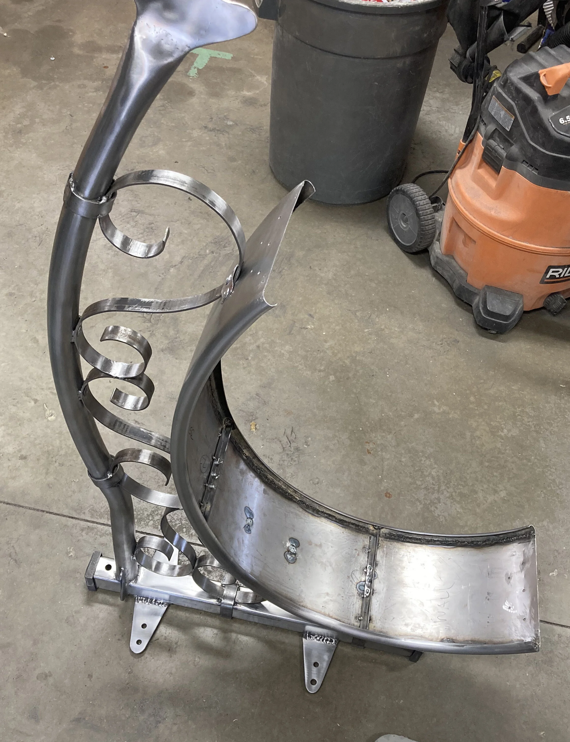 Here the sign is getting close to being ready for powder coating. Once coated, the sign would have crevices sealed with black silicone and the logo panels inserted. But much had to be done to get to this point…