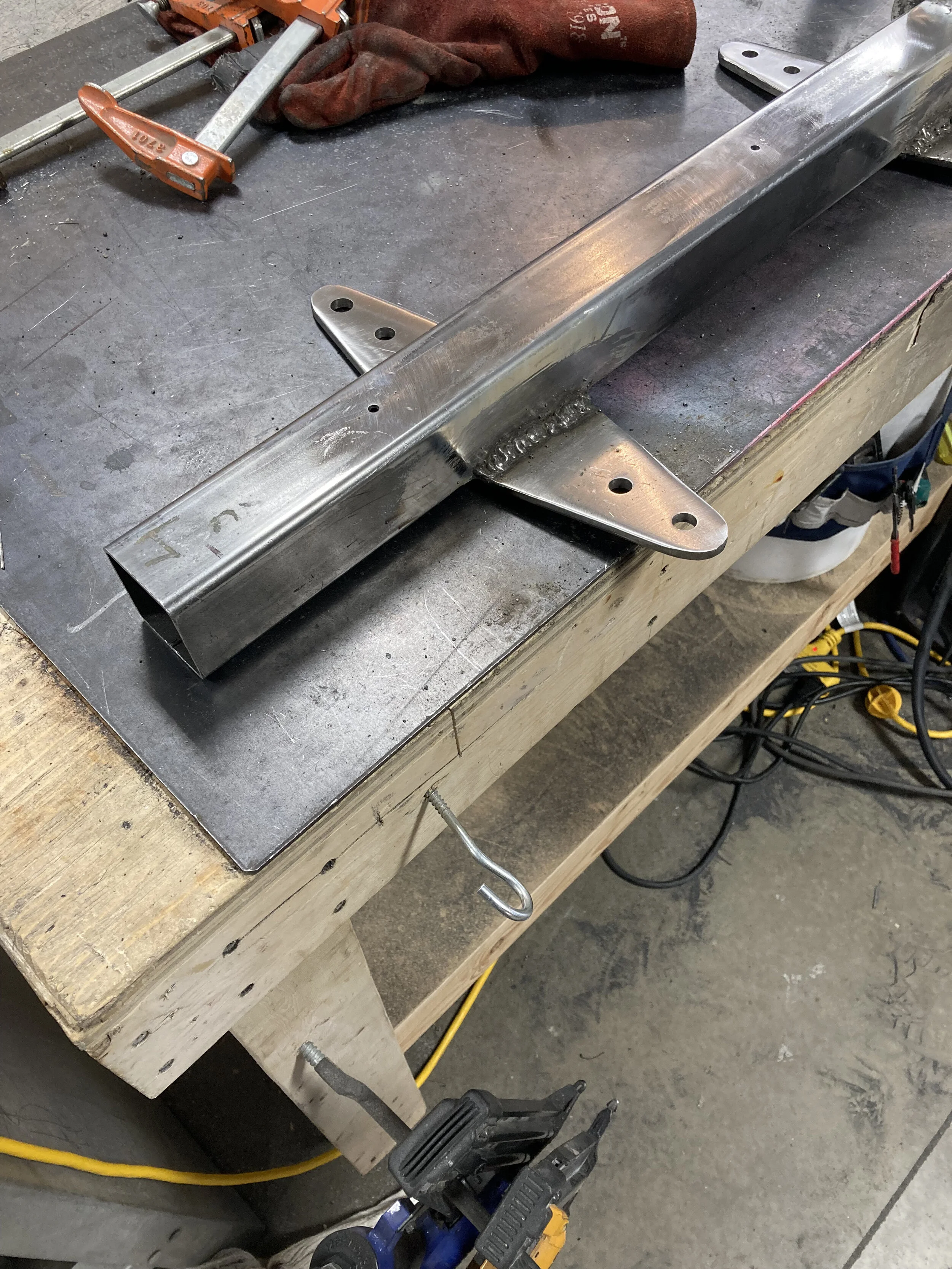 Fitting the support 'wings'. These must be beefy to resist lateral forces from wind gusts. They are also fitted at a 2º angle to rest flat against the shiplap building exterior. To ensure a 100% solid base, we actually removed part of the building