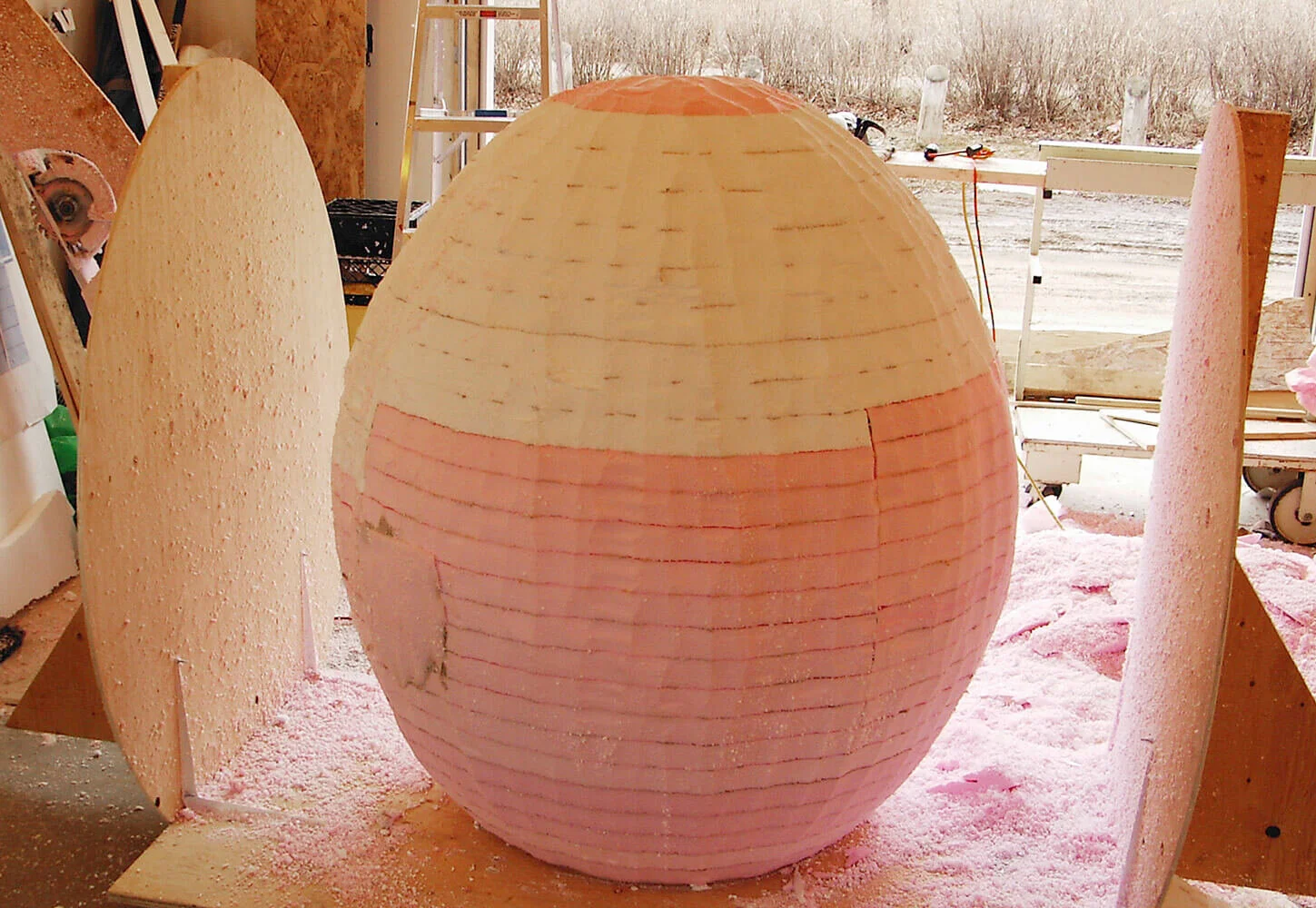 A circular saw attached to a 2"x4" mirrored the template shape, carving the egg as the whole block was turned slightly after each pass. The result was a perfectly symmetrical egg shape - something that would have been impossible by hand and eye.