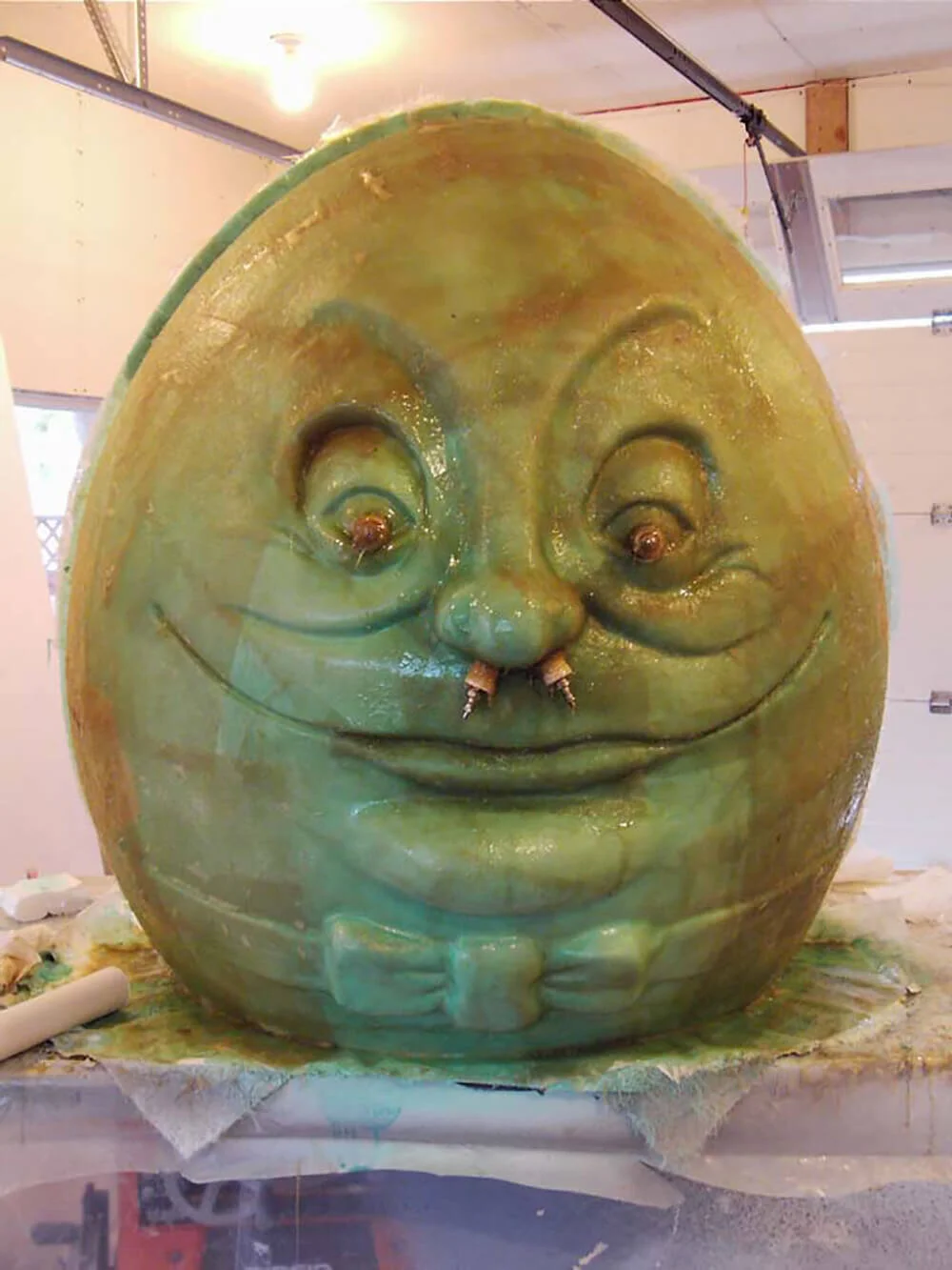 From the master ‘plug’, molds are made. Then from the molds, parts for the final figures are made. Here, the plug is covered in fiberglass that will be pulled off to become a mold. Air valves are inserted to assist in removing the mold from the p