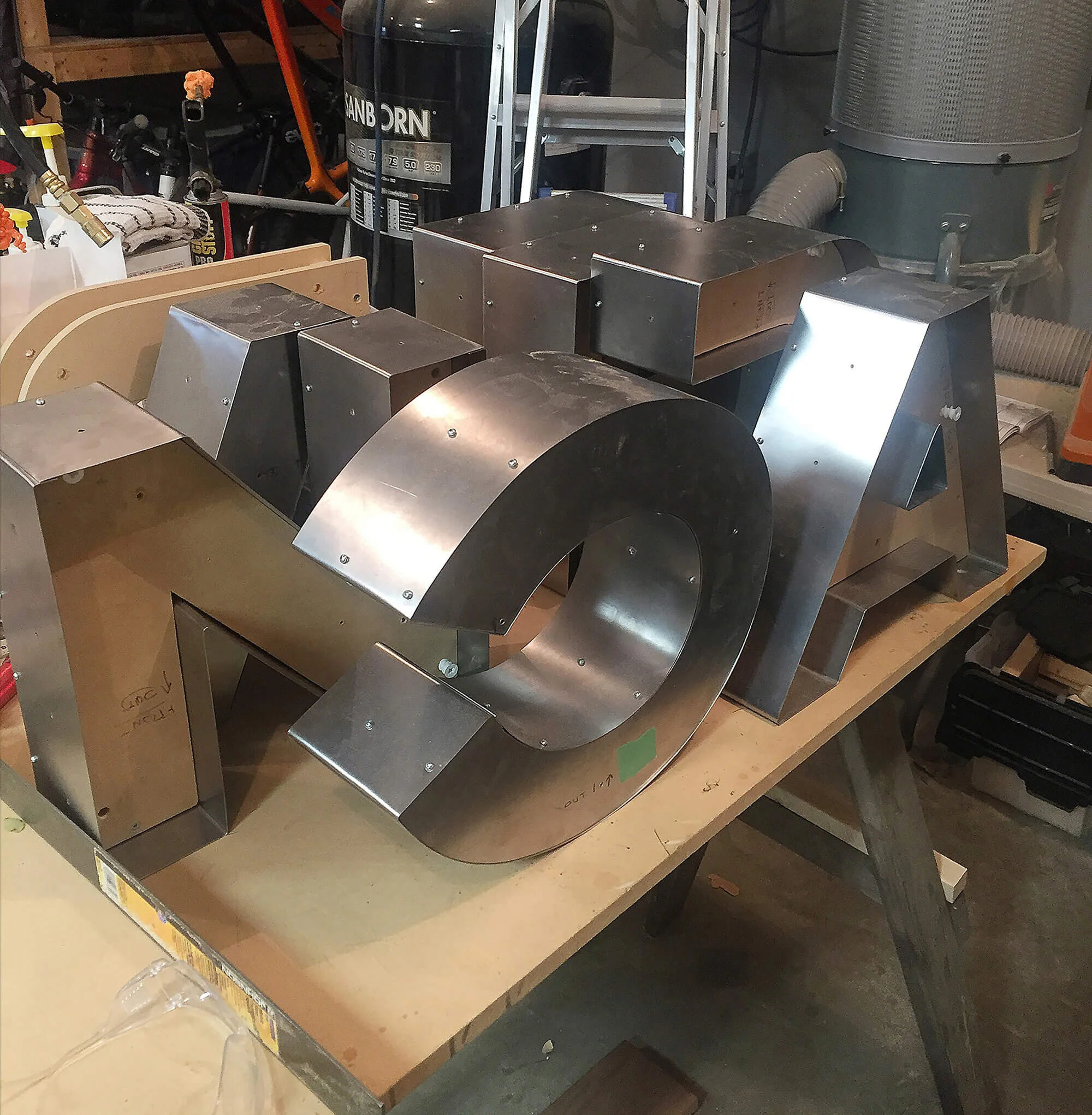 The finished letter shells ready for fitting to the display structure called an armature. The 'grass' and bulbs still need to be installed.